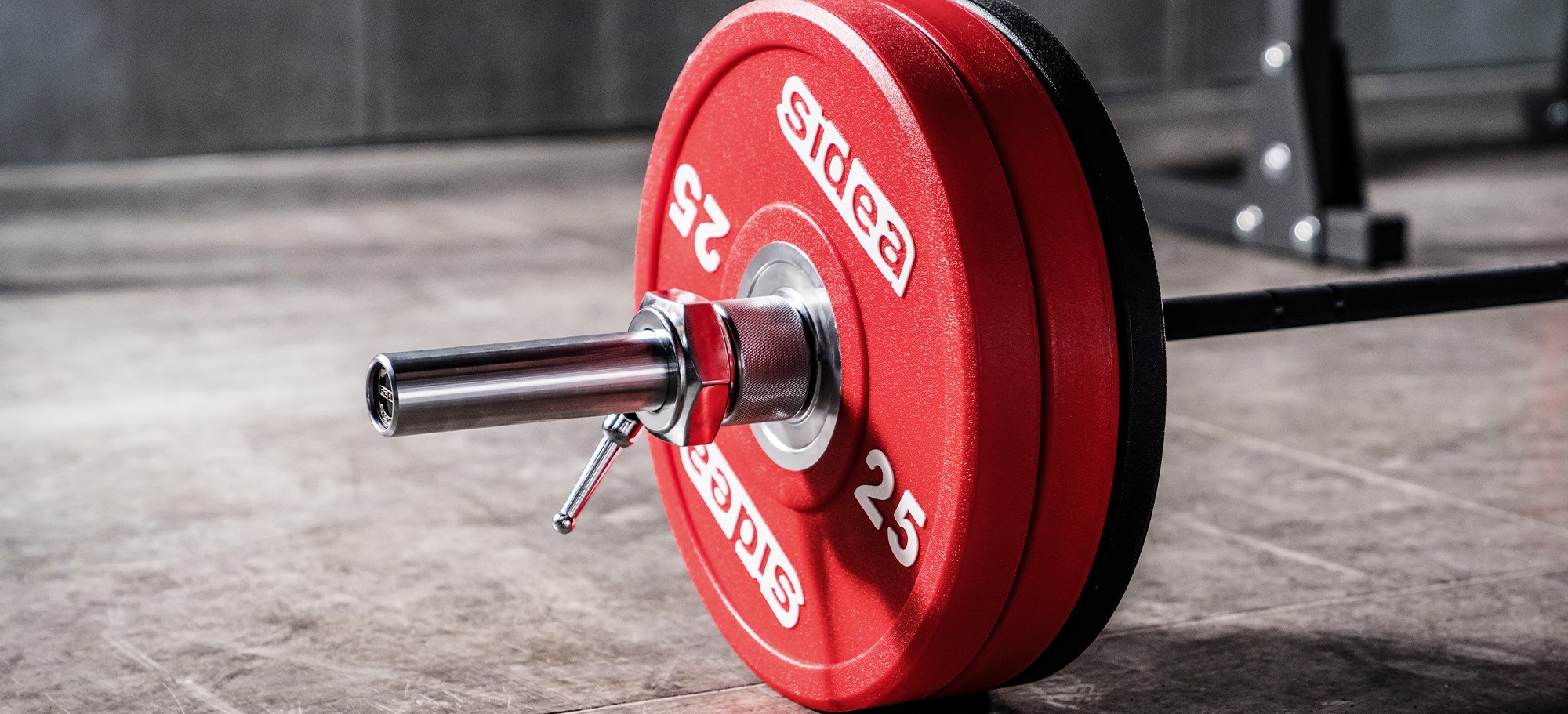 Sidea commercial barbell collars securing bumper weight plates on an Olympic barbell