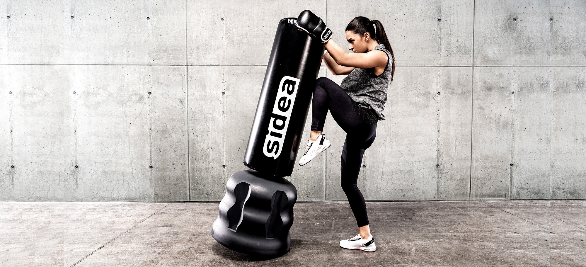Athlete striking a Sidea freestanding punch bag during a combat fitness training session