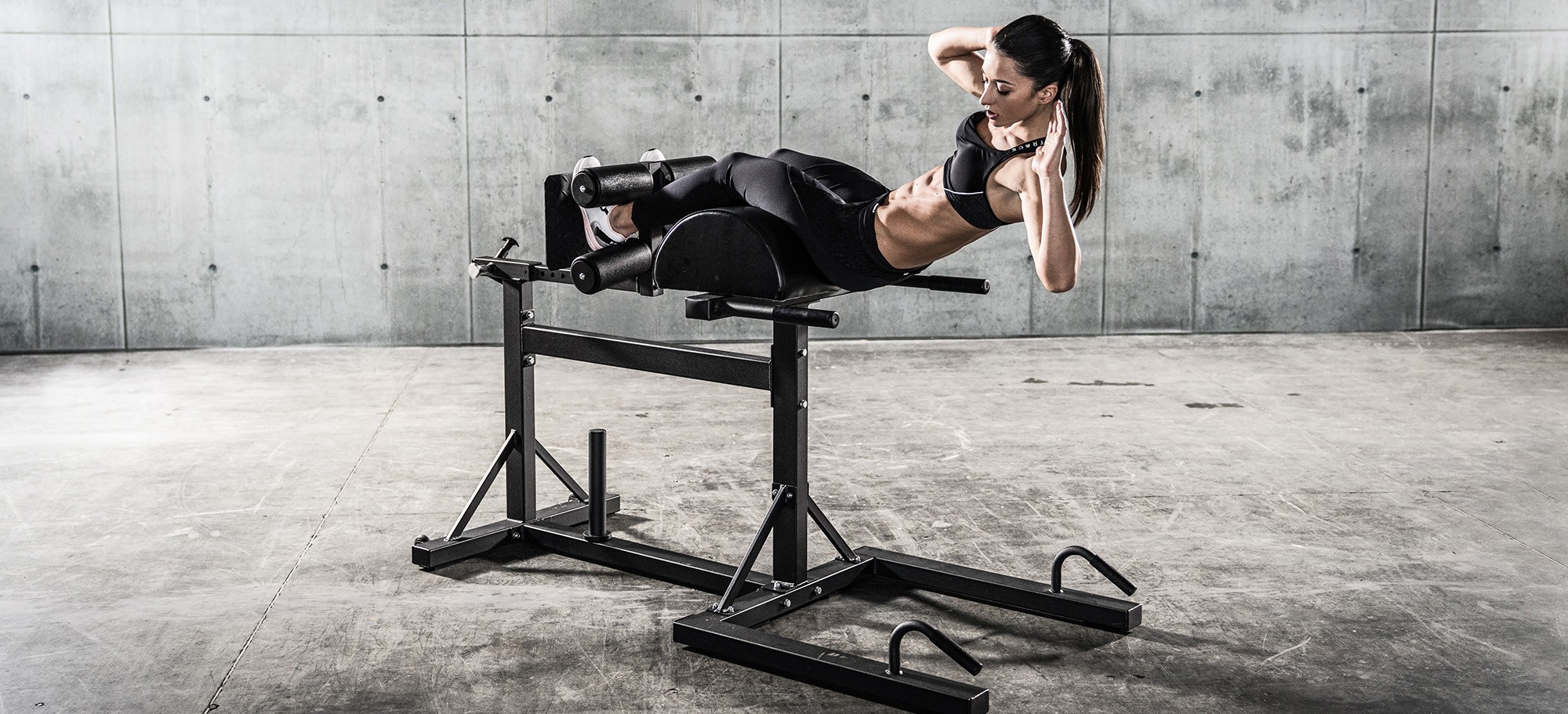 Athlete training posterior chain on Sidea commercial GHD benches