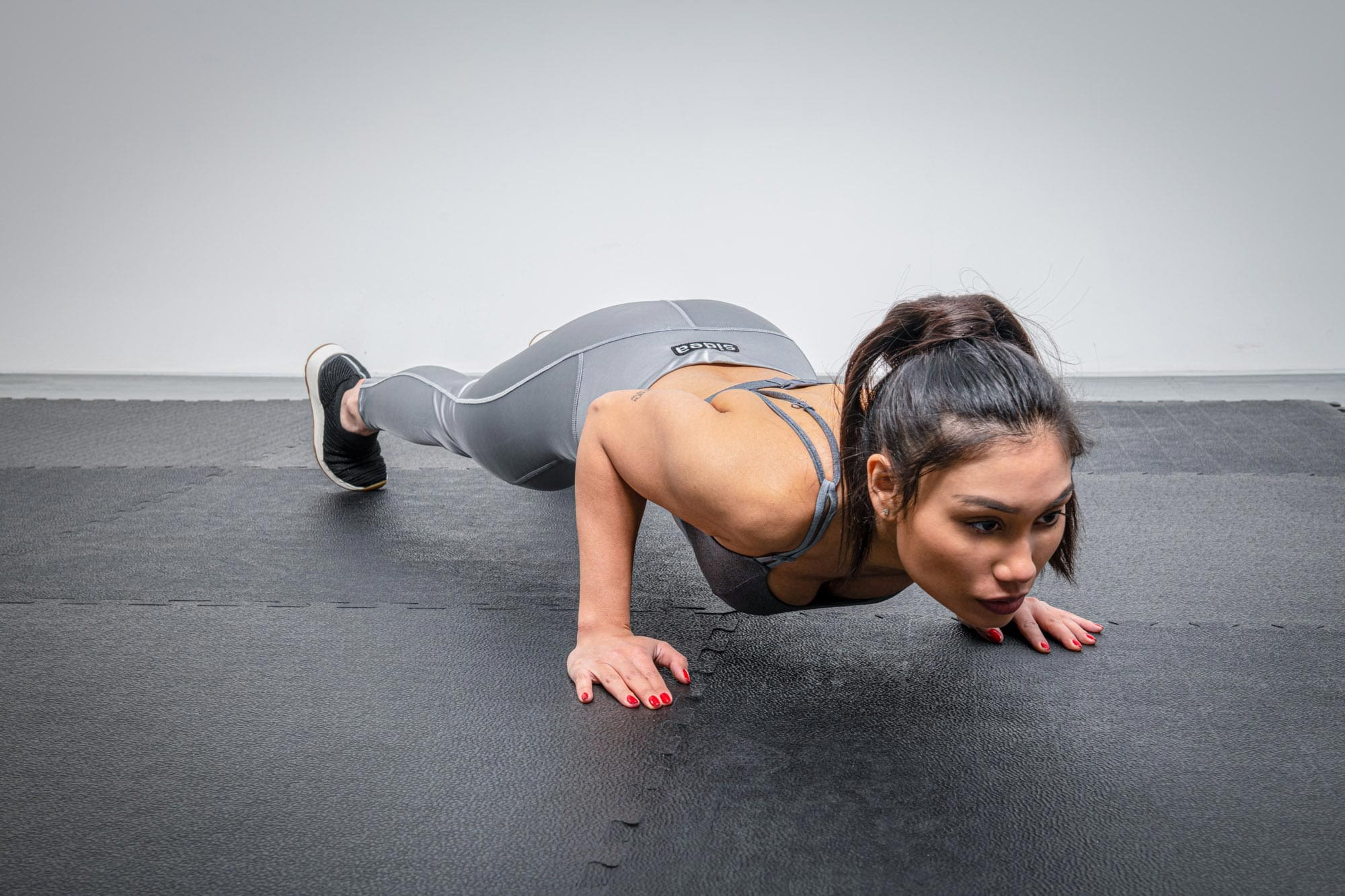 Athlete performing dynamic functional workouts on Sidea commercial gym flooring
