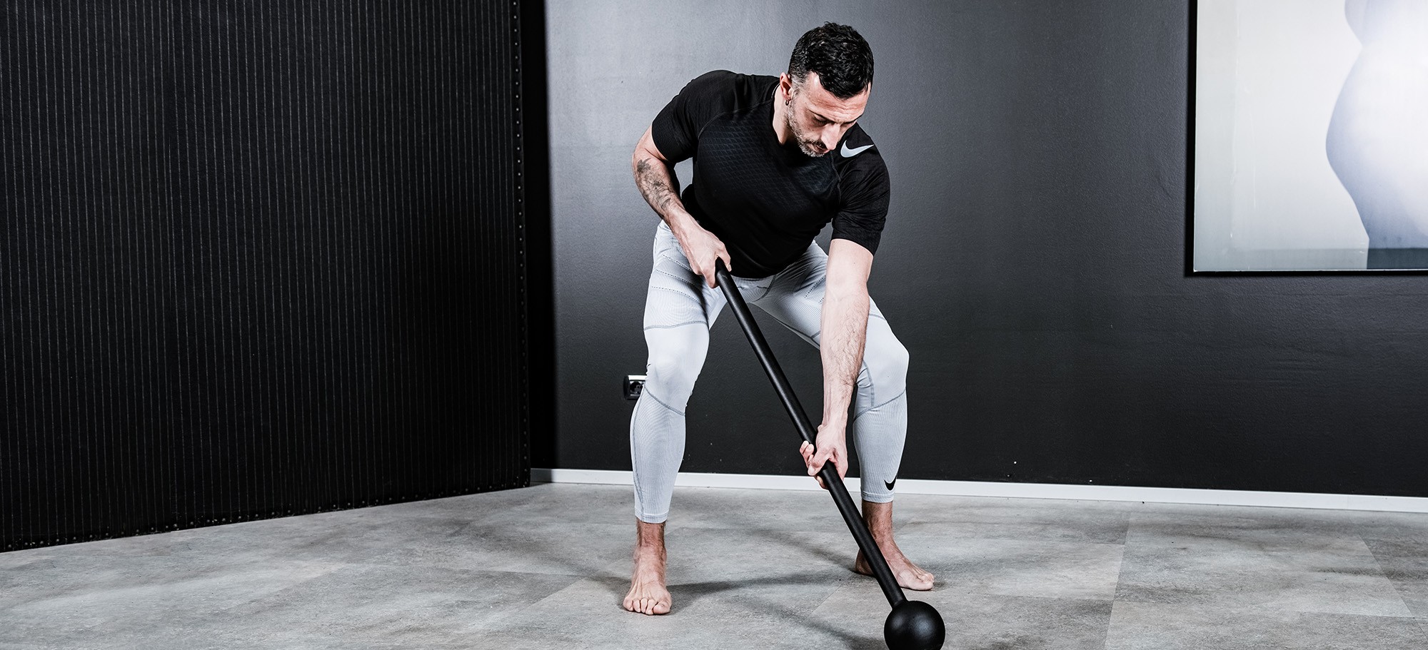 Athlete performing rotational strength training with Sidea commercial macebells and steel clubs