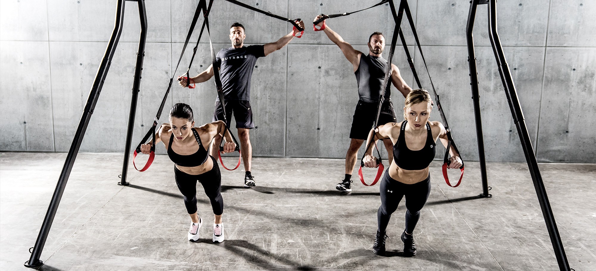 Athletes training with Sidea commercial suspension trainers on a rig setup