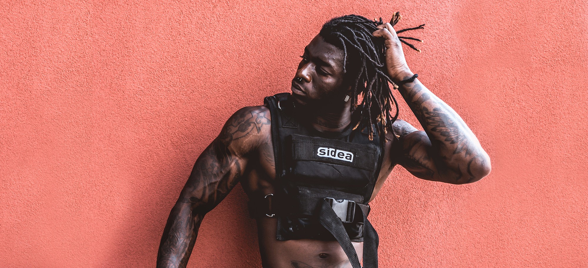 Male athlete wearing a black Sidea weighted vest during a functional fitness workout in Ireland
